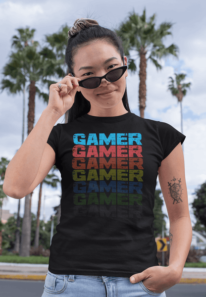 Female model standing in front of palm trees wearing black T-shirt with Faded Out Gamer Design from The Xpert Apparel Store