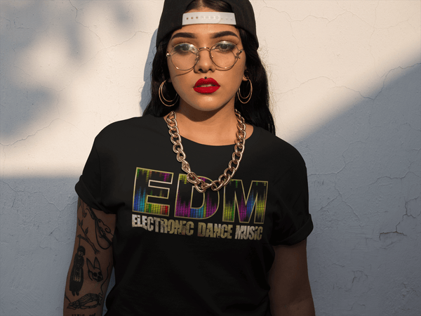 Girl with Tattoos and hat to the back  and gold chain wearing a Black T-shirt with EDM Eletronic Dance Music printed on the front, Gold textured available from the Xpert Apparel Store 