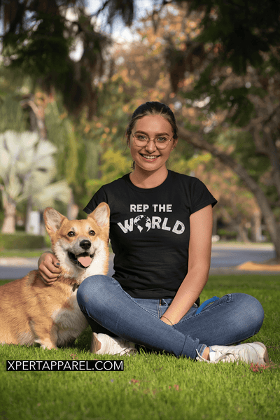 Girl sitting in the park with a border collie dog wearing a "Rep The World" T-shirt from the Xpert Apparel Store